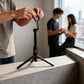 Fliq MagSafe tripod stable base close-up showing foldable leg construction